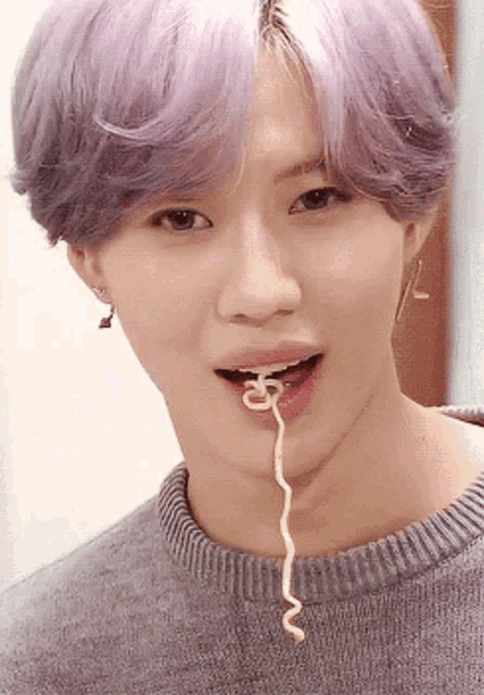 a young man with purple hair is eating noodles with the letter s coming out of his mouth
