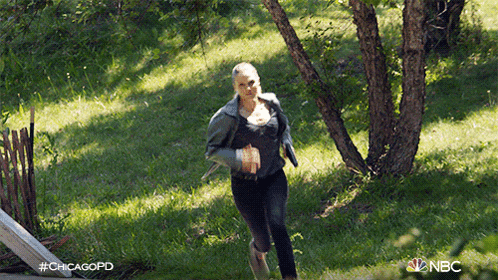 a woman is running through a grassy field with the hashtag #chicagopd on the bottom