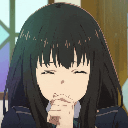a girl with long black hair is smiling with her hands folded