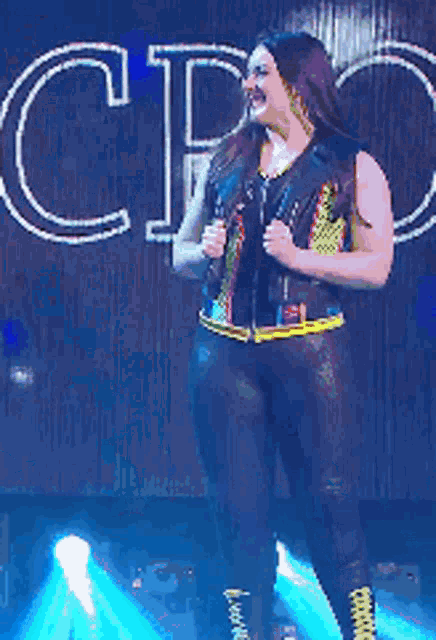 a woman is dancing on stage in front of a sign that says ctc