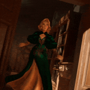 a woman in a green and gold dress is standing in a doorway