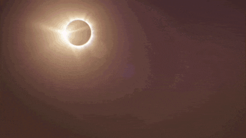 a city skyline with a partial eclipse of the sun