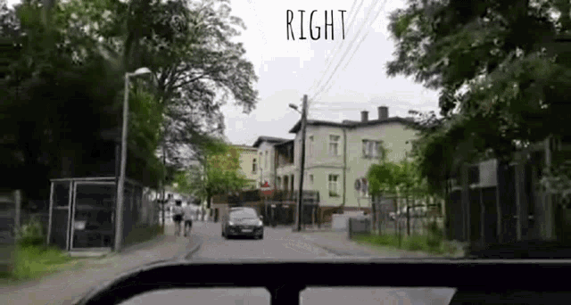 a car is driving down a street with a sign that says right on it .
