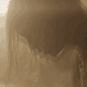 a close up of a woman 's face in the fog .