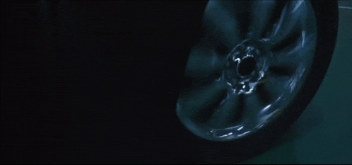 a close up of a car wheel with a black background