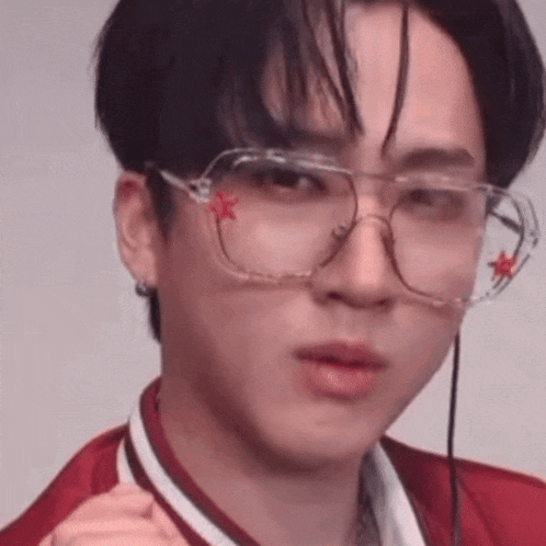 a close up of a person wearing glasses with a red star on them .