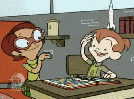 a cartoon of a boy and a girl sitting at a desk looking at a book .