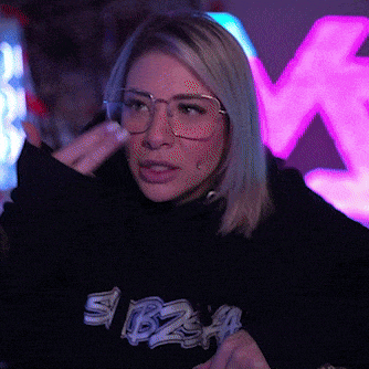 a woman wearing glasses and a sweater that says ibiza