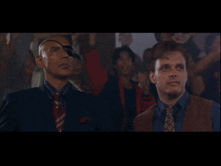 two men in suits and ties are standing next to each other