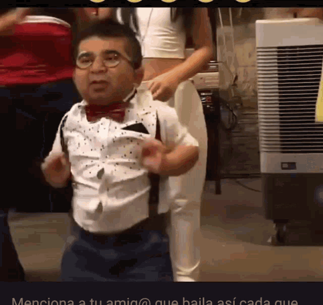 a man in a bow tie and suspenders dancing