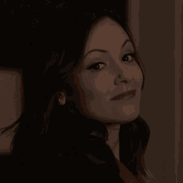 a close up of a woman 's face with her eyes closed