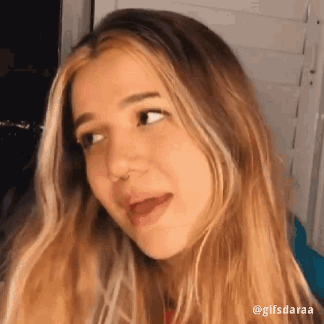 a close up of a woman making a funny face with her mouth open .