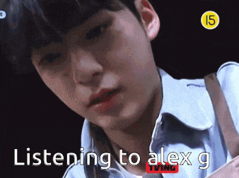 a close up of a person 's face with the words listening to alex g on the bottom