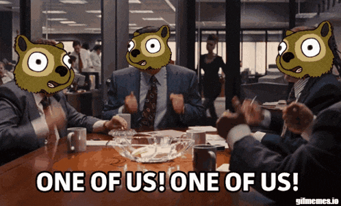 a group of people sitting around a table with one saying one of us one of us