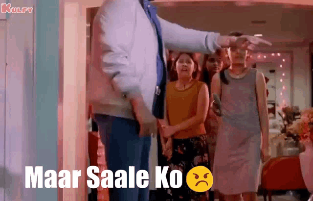 a group of people are standing in a room with the words maar saale ko written in the corner
