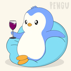 a penguin sitting on a bean bag chair with a glass of wine