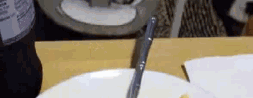 a plate of food with a knife and fork on it on a table .