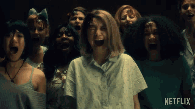 a group of women are screaming in front of a netflix ad