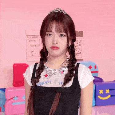 a girl with braids and a necklace with a red star