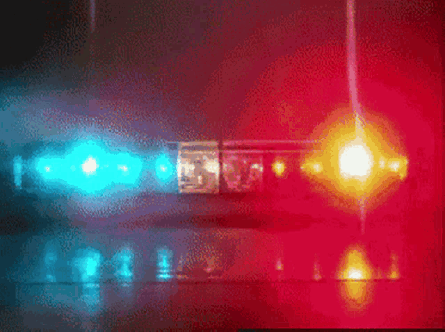 a blurred image of a red and blue light that says ' emergency ' on it