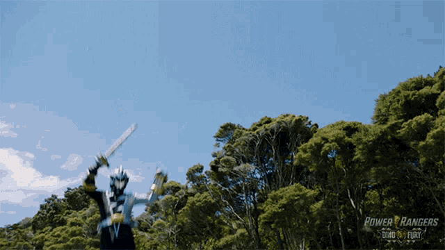 a power rangers poster shows a man holding a sword in a forest