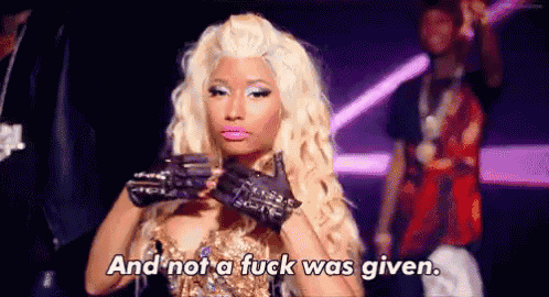 a woman with blonde hair and gloves is standing in front of a crowd and says `` and not a fuck was given '' .