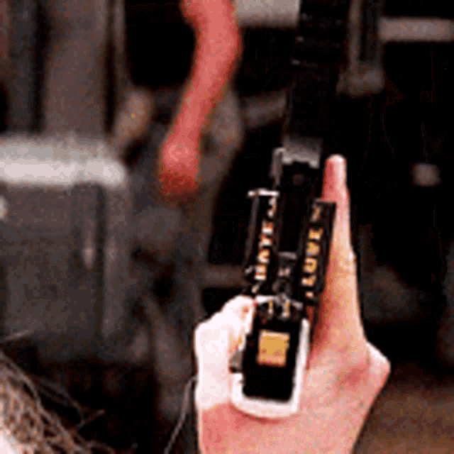 a close up of a person holding a gun with the word tarot on the side