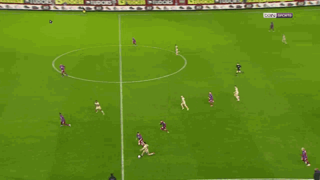 a soccer game is being played on a field with advertisements for tudor 's on the sidelines