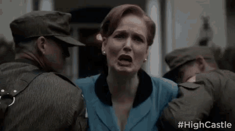 a woman is being held by two soldiers in front of a white house .