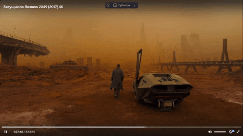 a video of a man standing next to a car that says 2049 2017 4k
