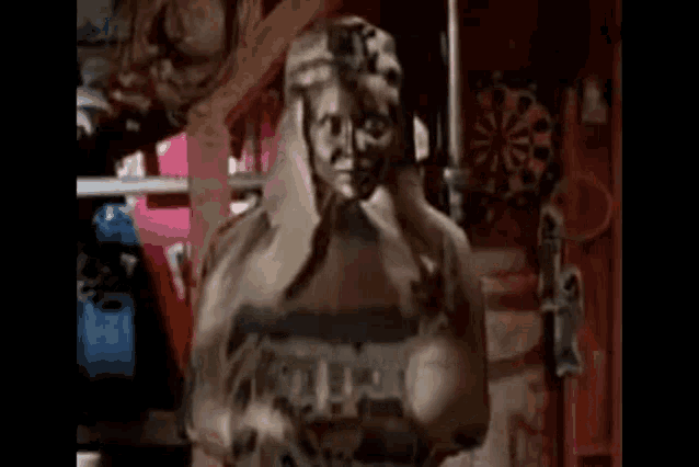 a statue of a woman is sitting in a room with a dart board in the background .