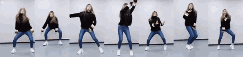 a woman in a black sweater and jeans is dancing in a room