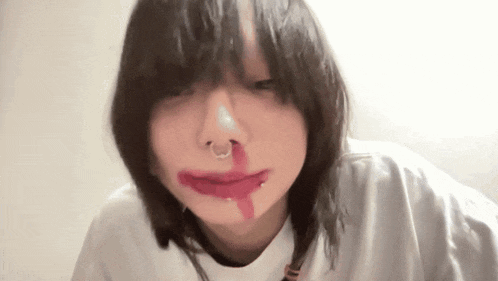 a woman with a nose ring and red lipstick on her lips .