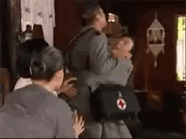 a man is being lifted in the air by a woman in a living room