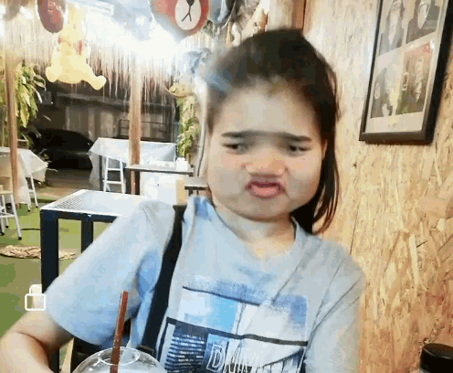 a girl wearing a t-shirt that says dna on it is making a funny face