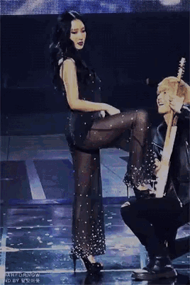 a man kneeling down next to a woman on a stage with the words tomorrow written on the bottom