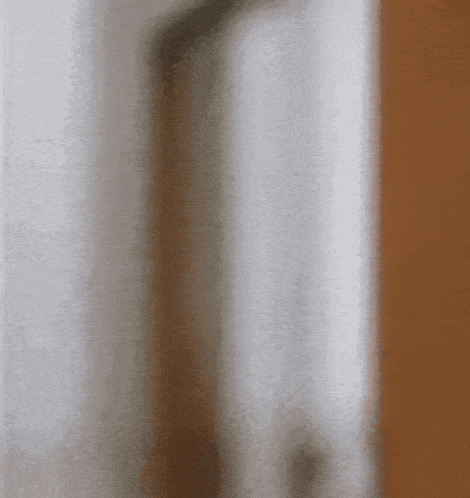 a blurred image of a person standing in a doorway