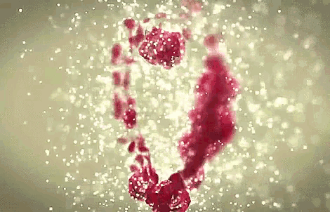 a close up of a red liquid with bubbles coming out of it .