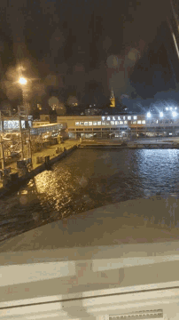 a view of a river with a building that says ' rotterdam ' on the side