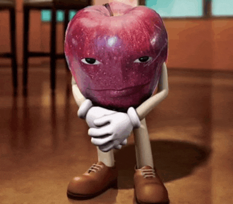 a cartoon apple with arms and legs is sitting on the floor with his hands folded .