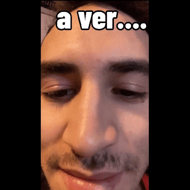 a close up of a man 's face with the words a ver written above it