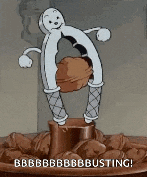 a cartoon character is holding a nutcracker over a bowl of nuts and nuts .