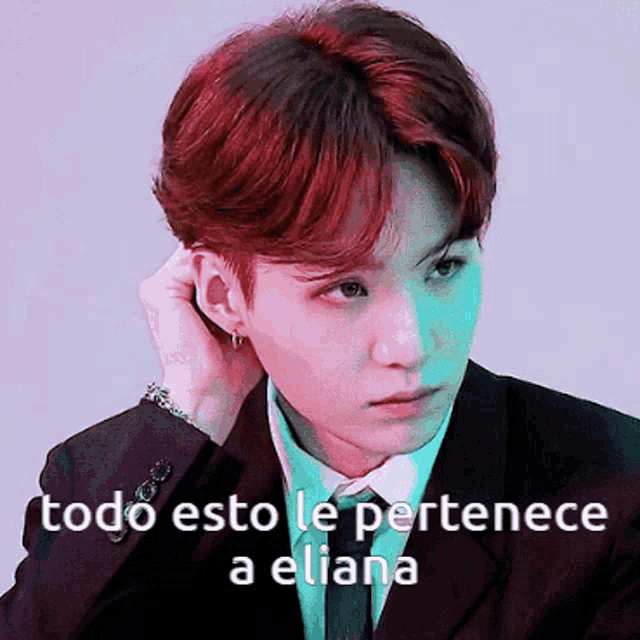 a man in a suit and tie with the words todo esto le pertenece a eliana written below him