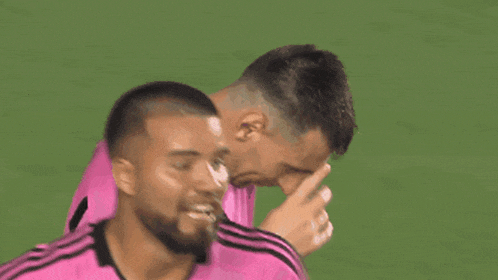 two soccer players wearing pink jerseys with the adidas logo on them