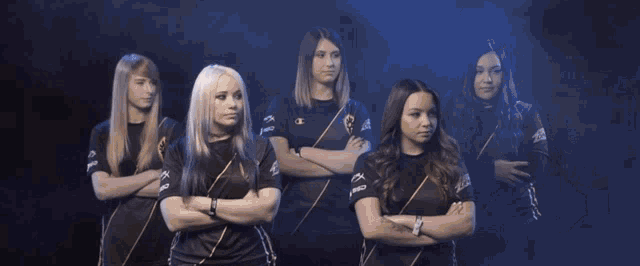 a group of women are standing in front of a camera and one of their shirts says aoc