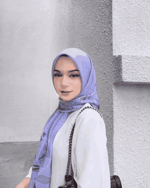 a woman wearing a white veil with a blue sky behind her