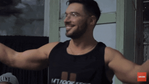 a man wearing a black tank top that says " tattoo "