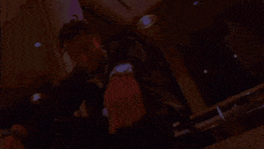 a man is sitting on a table with his arms outstretched .