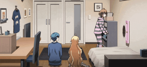 a girl in a striped pajama is standing in a room with two other girls