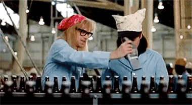 a man and a woman are standing next to each other in a factory